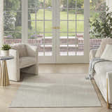 Living room scene with ivory sofa and Nourison Courtyard Ivory Silver Modern Area Rug, light and airy.