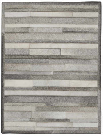 Close-up of the Calvin Klein Home Prairie Silver rug. Features horizontal stripes of gray and white hair-on-hide.