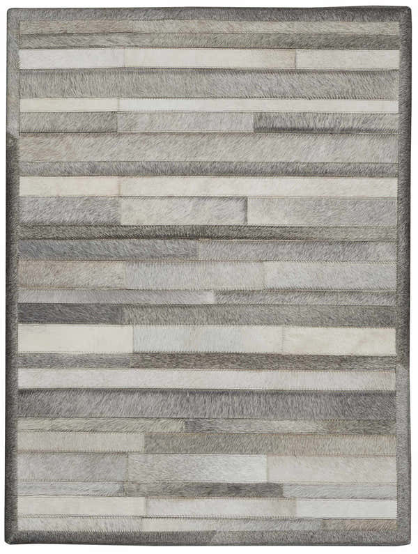 Close-up of the Calvin Klein Home Prairie Silver rug. Features horizontal stripes of gray and white hair-on-hide.