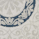 Close-up of Nourison Key Largo Blue rug showing light blue floral pattern on a textured, machine-made contemporary rug.