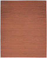 Brick red Nourison Essentials washable rug. Close up of the modern, machine-made area rug.