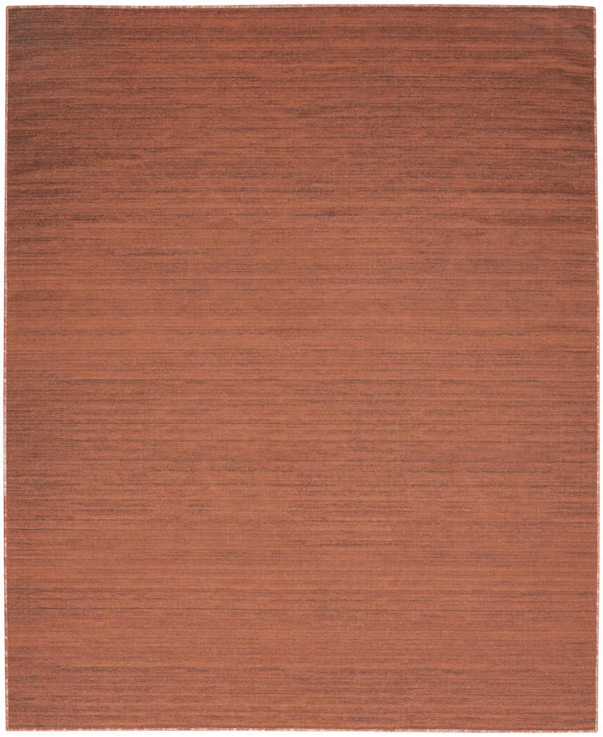 Brick red Nourison Essentials washable rug. Close up of the modern, machine-made area rug.