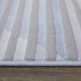 Close-up of Feizy Marigold rug. Modern geometric design in blue, gray, and white stripes. Soft, textured pile. Pile