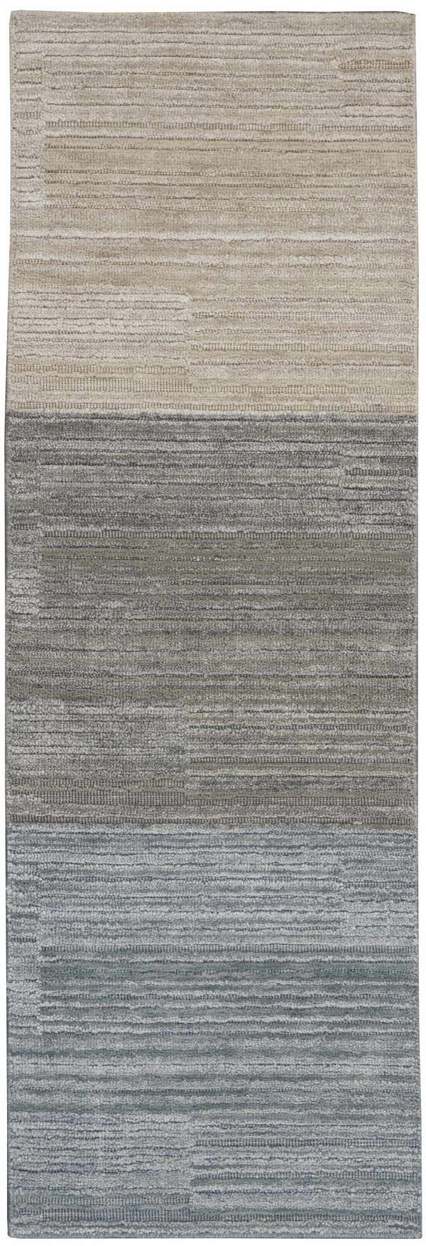 Close-up of Calvin Klein Abyss Sand rug. Contemporary design in light blue, sandstone, and silver gray with a subtle horizontal pattern.