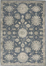 Close-up of the Nourison Quarry Blue Beige Vintage Area Rug featuring a floral pattern and border.