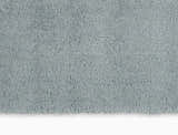 Close-up of the Calvin Klein Chicago Shag rug. Soft, dense pile in light grey. Modern, plush texture.