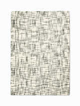 Close-up of the Calvin Klein Tucson Ivory/Grey rug. Handmade wool rug with a modern, abstract grid pattern.