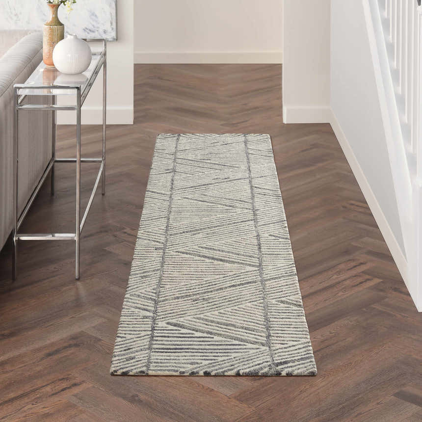 Hallway with Nourison Colorado Grey White runner rug, wood floors, and modern console table.