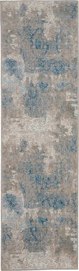 Close-up of Nourison Karma Ivory/Light Blue rug with vintage chestnut pattern and soft texture. Clearance.