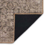 Close-up of the Four Hands Priya Area Rug showing its camel, light beige, and tan traditional pattern and black backing. Fold
