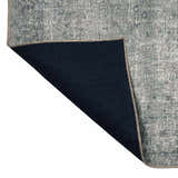 Close-up of the Four Hands Morelli Blue Area Rug showing the rug's backing and woven texture. Fold