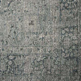 Close-up of the Four Hands Morelli Blue Area Rug, showing its woven texture and traditional vintage pattern. Texture