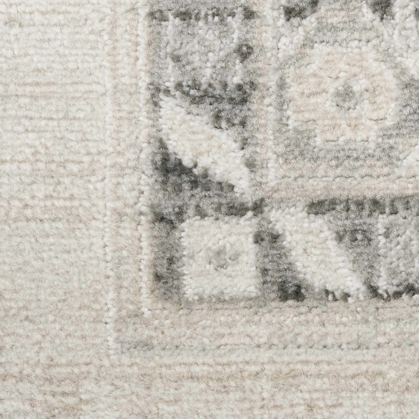 Close-up of the high pile Nourison Serenity Home Ivory Grey rug with a vintage-inspired pattern and texture.
