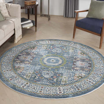 Living room with a round Nourison Ankara Global rug in ivory and light blue, bohemian style.