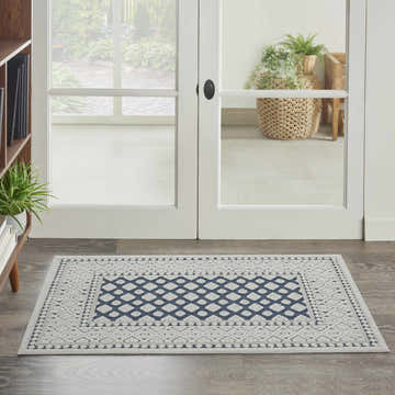 Entryway with Nourison Key Largo Blue Transitional Area Rug, featuring a geometric diamond pattern in blue and light gray.