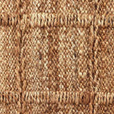 Close-up of the Four Hands Grid Jute Rug. Hand-woven natural jute fibers create a textured grid pattern. Farmhouse style. Texture