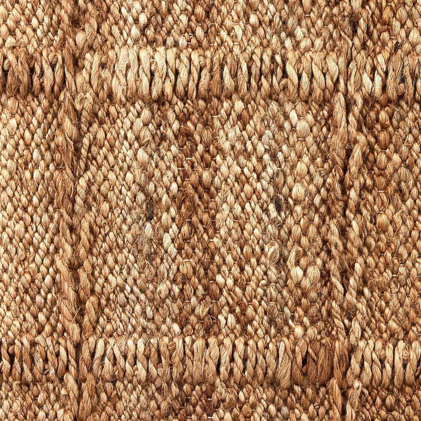 Close-up of the Four Hands Grid Jute Rug. Hand-woven natural jute fibers create a textured grid pattern. Farmhouse style. Texture