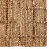 Close up of the Four Hands Grid Jute Rug, showcasing its natural jute fibers and hand woven grid pattern. Swatch