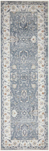 Close-up of the Nourison Astra Machine Blue Vintage Area Rug. Features a distressed, ornate pattern and light blue color.