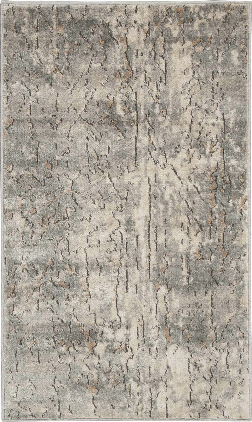 Close-up of a Nourison Quarry Beige Gray rug. Features a distressed, abstract pattern with beige, gray, and brown hues.