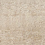 Close-up of the beige Calvin Klein CK043 Spun rug. Handmade New Zealand wool with a nubby, textured farmhouse design.