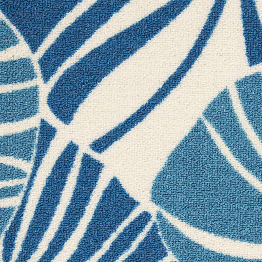 Close-up of Waverly Sun N' Shade Blue Tropical Area Rug featuring a light blue tropical leaf pattern on an ivory background.