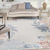 Living room scene with a Nourison Seaside Ivory Multicolor rug featuring coral and seahorse designs.