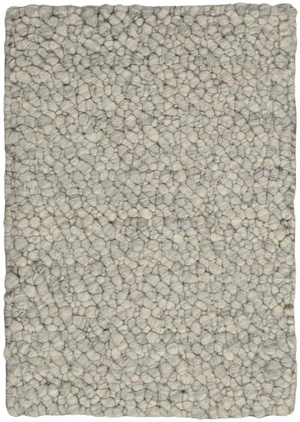 Close-up of the Calvin Klein Riverstone rug. Grey and ivory wool with a textured, pebble-like design. Handmade.