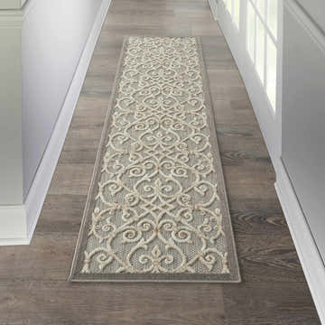 Hallway with Nourison Aloha Natural runner rug. Beige scroll pattern on gray polypropylene.