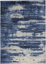 Close up of the Calvin Klein River Flow rug; blue, grey, and black mid-century modern design.