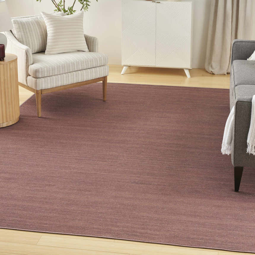 Living room scene with Nourison Essentials Mocha rug, light brown tones, mid-century modern furniture.