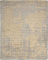 Close-up of Nourison Harmony Grey Gold rug. Modern design with abstract gold pattern on a textured gray wool blend.