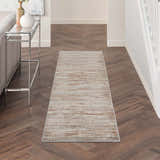 Entryway with Nourison Elation Ivory Grey rug runner on dark wood floors, console table, and neutral decor.