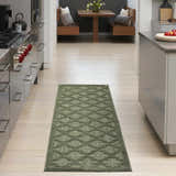 Modern kitchen with a Nourison Easy Care Green Modern Area Rug runner on light wood floors.