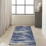 Modern entryway with a Calvin Klein River Flow Blue Grey rug, light wood floors, and neutral decor.