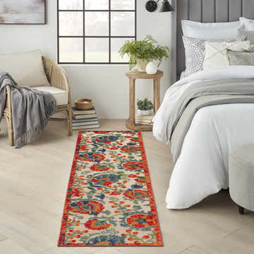 Farmhouse bedroom scene with a Nourison Aloha Red Multicolor runner rug, bed, chair, and natural light.
