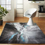 Modern living room with Nourison Le Reve Charcoal Multicolor rug, white chair, wood floors, and city view.