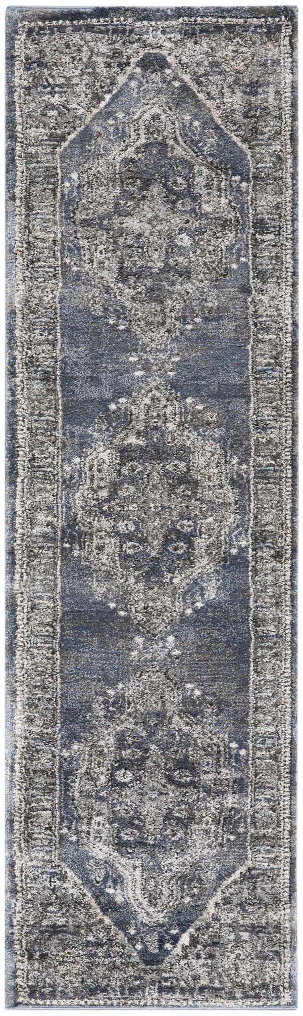 Close-up of the Nourison American Manor Blue Farmhouse Indoor Area Rug featuring a distressed, light blue pattern.