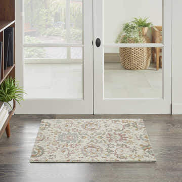 Entryway with Nourison Twilight Ivory Multicolor rug, wood floors, and white french doors to a garden.