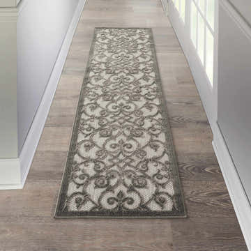Hallway with Nourison Aloha Grey Charcoal runner rug on wood floor. Contemporary style.