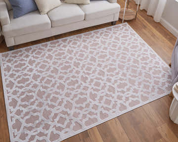 Living room with Feizy Saphir Mira pink and white rug under a cream sofa on wood floor. Modern geometric design. Roomscene-Rectangle