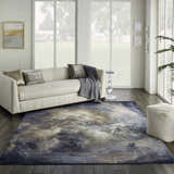 Living room with cream sofa and Nourison Le Reve Chocolate Multicolor rug with cloud-like pattern on dark wood floor.