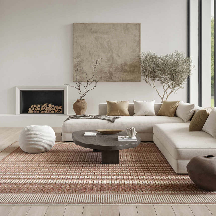 Living room scene with a Nourison Nordic Brick Ivory rug, sectional sofa, fireplace, and modern decor.