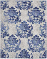 Close-up of the Nourison Whimsicle Ivory Navy rug, featuring a blue damask pattern on a neutral, farmhouse-style background.