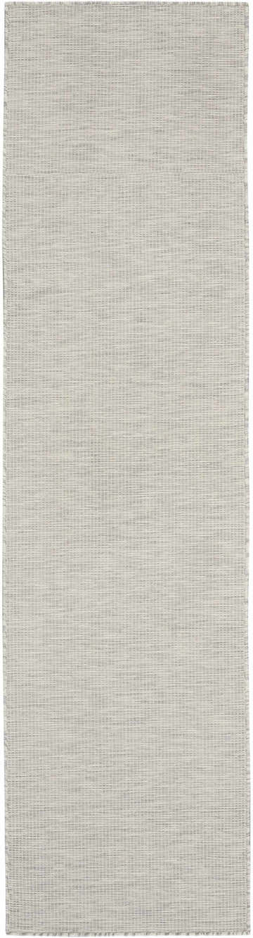 Close-up of the Nourison Positano Light Grey Area Rug. Woven texture with subtle horizontal lines. Neutral, light gray color.