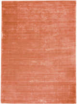 Close-up of the Calvin Klein Home Lunar Rust rug, showing its subtle horizontal striations and soft, textured weave.