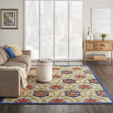 Living room scene with Nourison Aloha Blue Multicolor rug, sofa, ottoman, and wood console table.