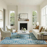 Living room with a Nourison Jubilant Ivory Blue Farmhouse Indoor Area Rug, sofa, chairs, fireplace, and natural light.
