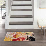 Entryway with a Nourison Prismatic Multicolor rug, wood floors, white stairs, and a modern white bench.
