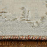 Close-up of the Feizy Jaxson rug showing its gray, ivory, and orange abstract design and textured wool blend. Pile